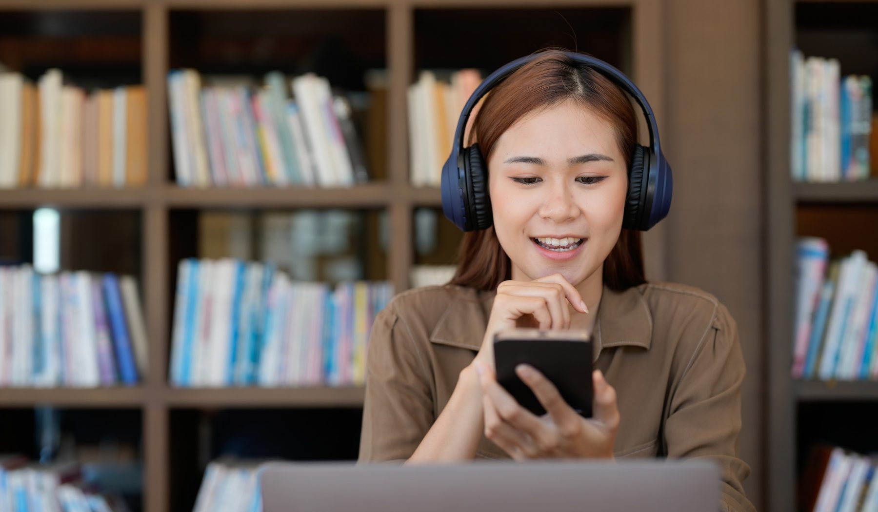 Asian tutor of language start online lesson with trainee wave hand smiling looks at pc screen