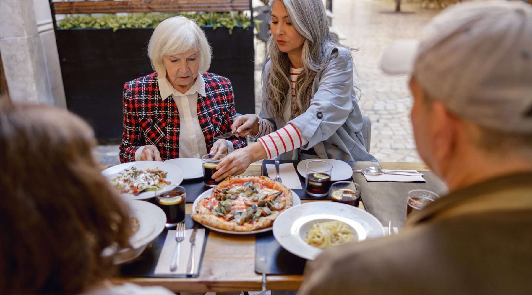 Female friends having conversation at street cafe
