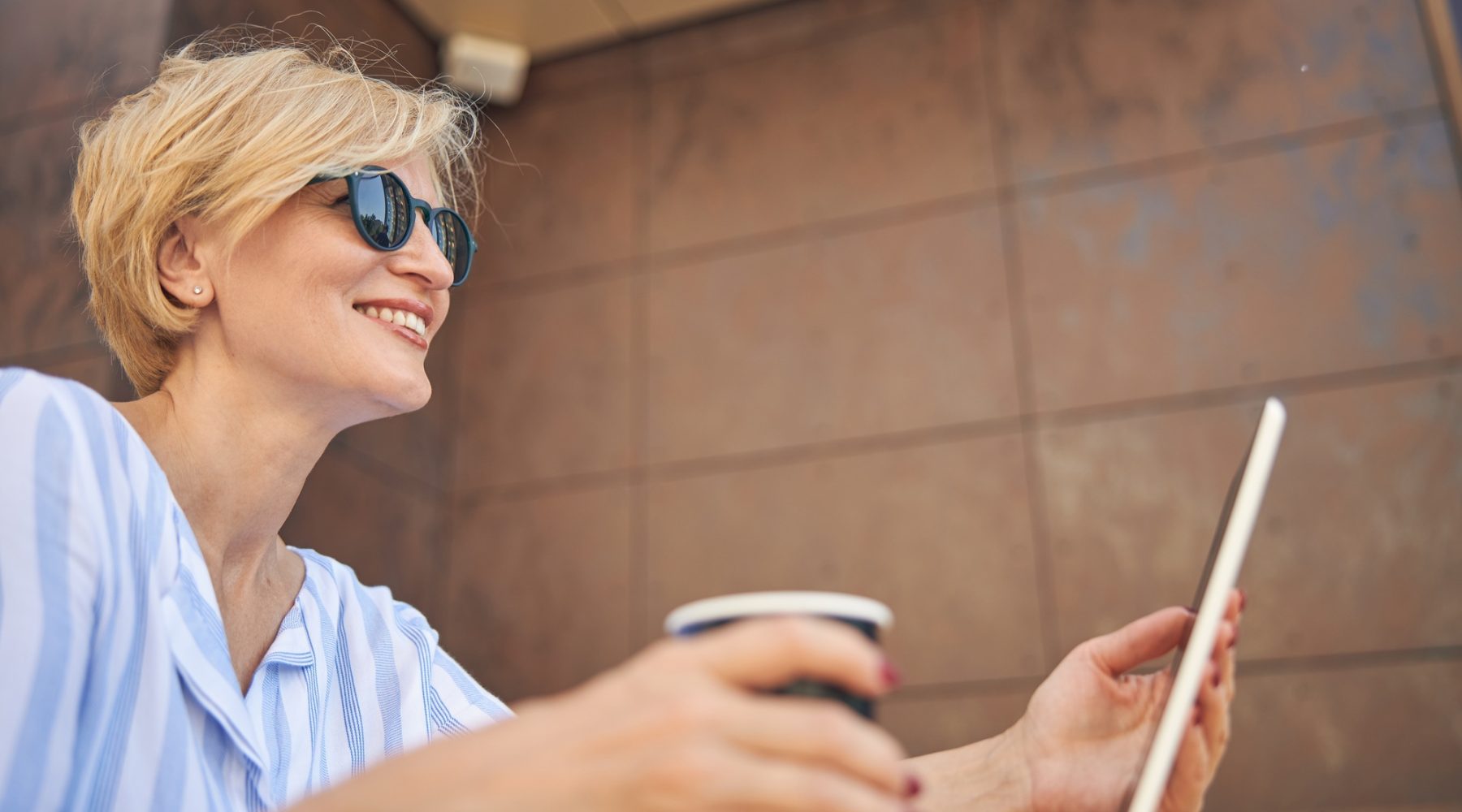 Joyful lady sitting in a street cafe