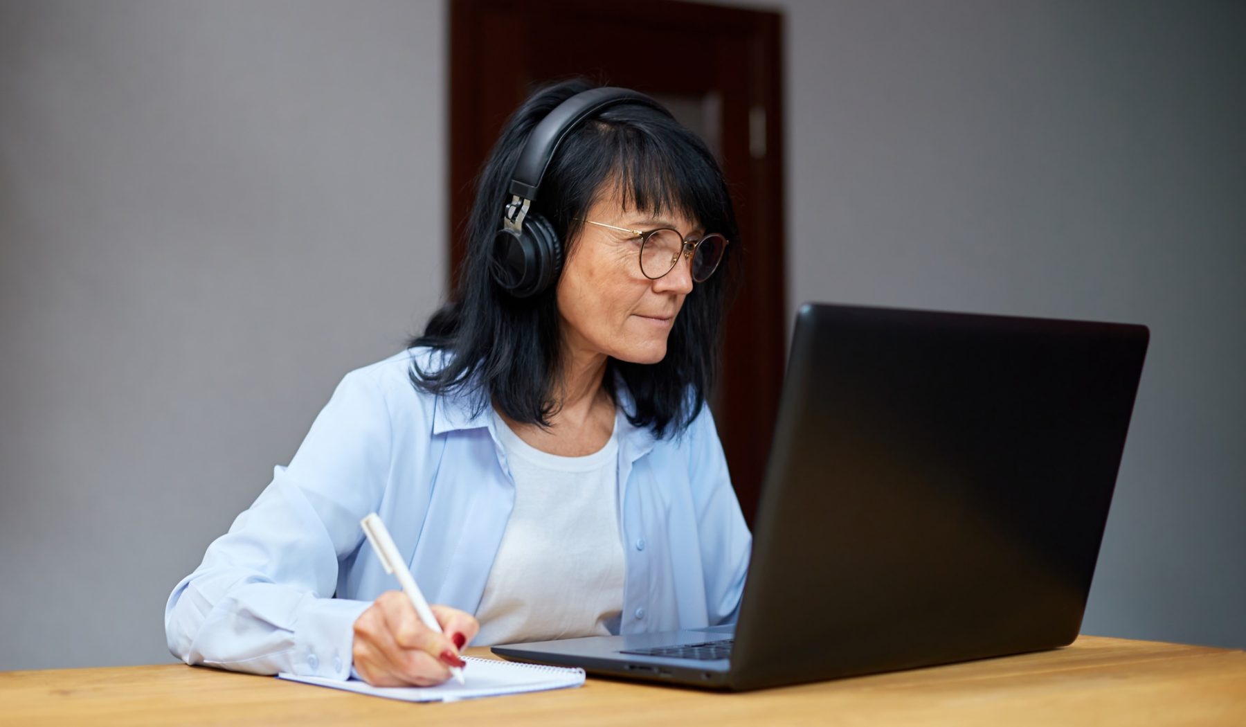 Senior woman student learning language, watching online course