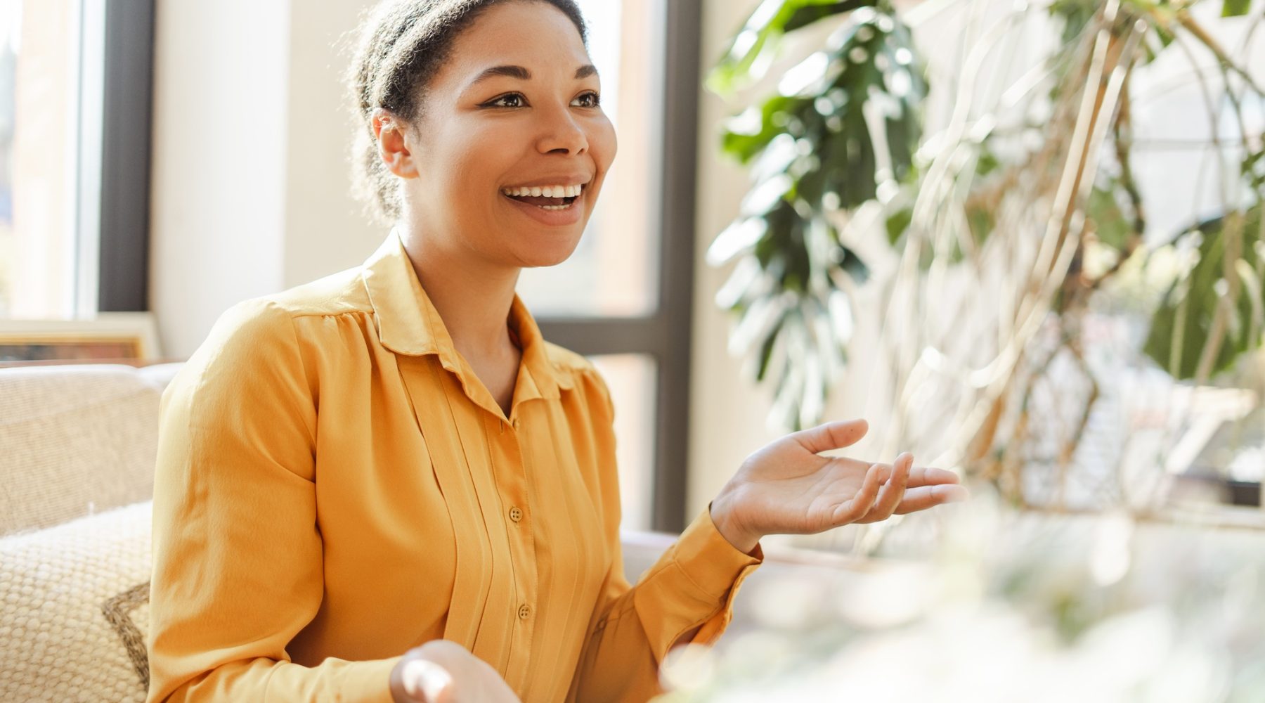 Smiling african american woman learning and communicating in sign language